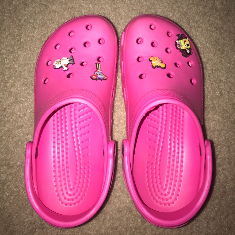 Pink crocs with jibbitz.